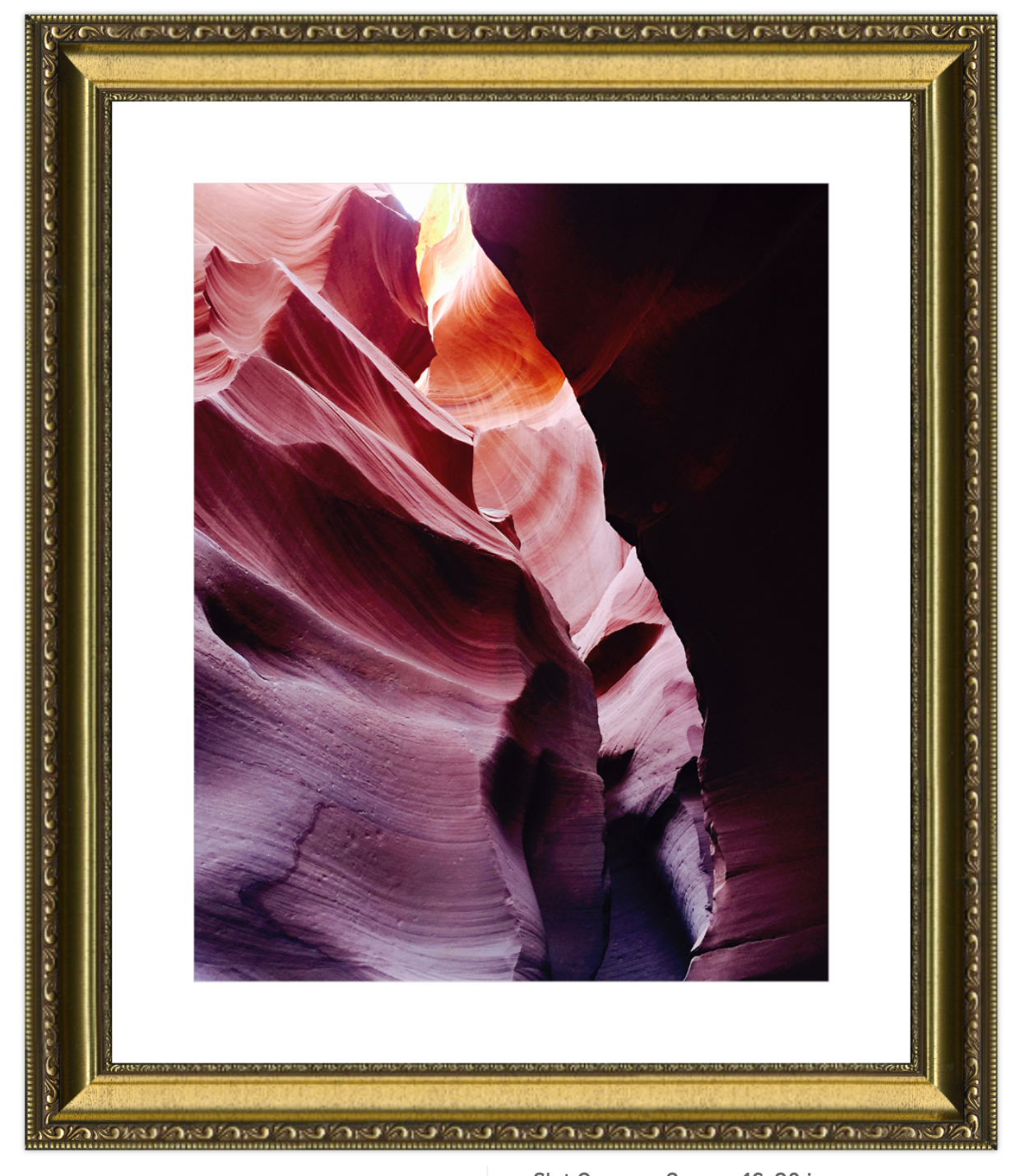 Framed photograph of a colorful canyon formation with a gold frame.