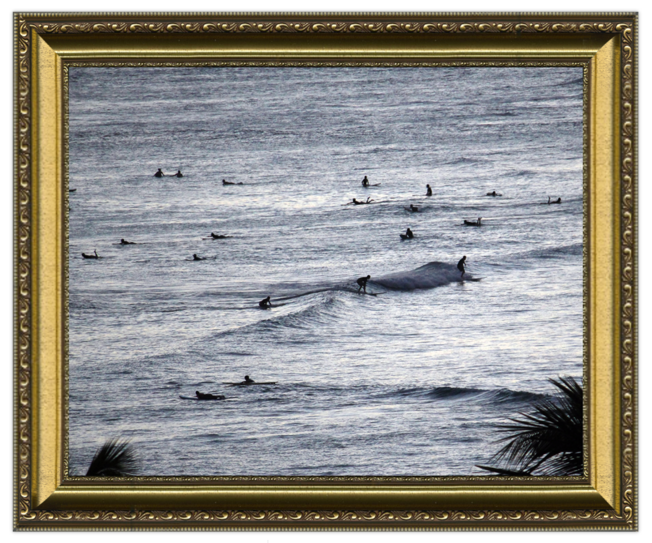 Framed artwork of a whale in the ocean with surfers, framed in gold.