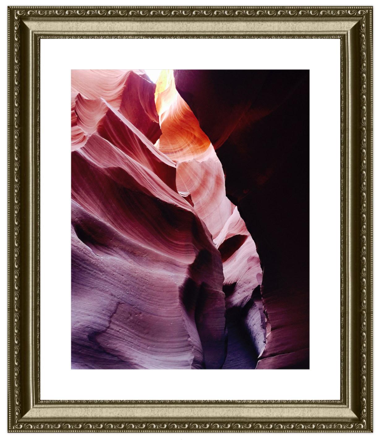Framed photograph of a colorful rock formation with a white border and gold frame.