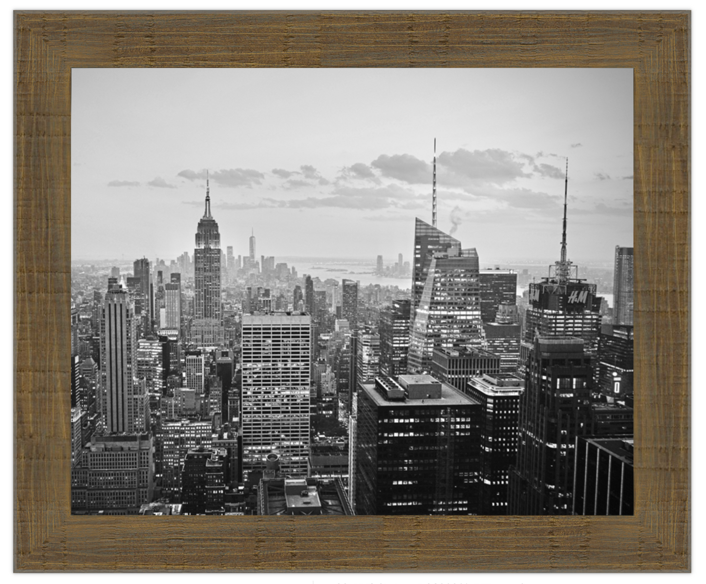 Framed black and white cityscape of a large metropolitan area with tall buildings.