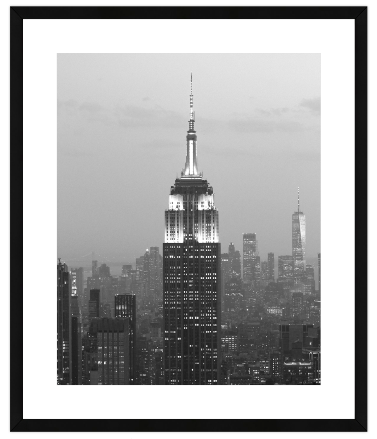Framed black and white photo of a cityscape with a prominent skyscraper.