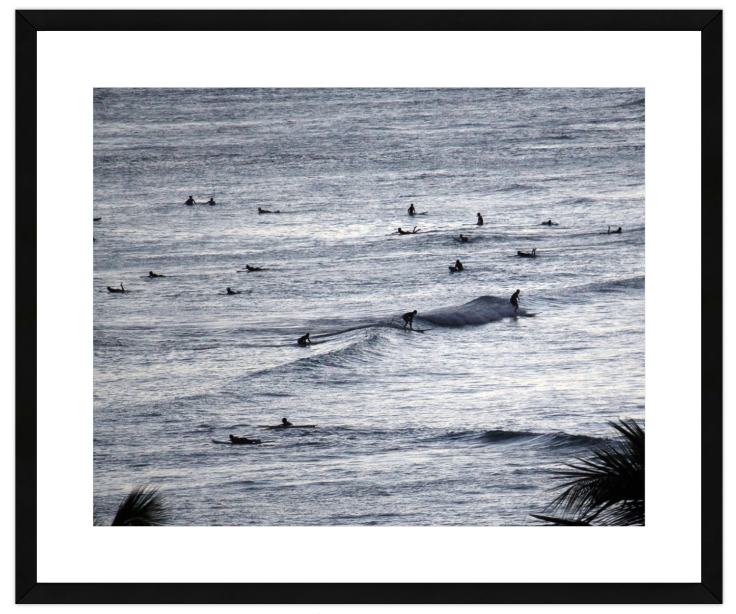 Framed artwork of ocean with surfers