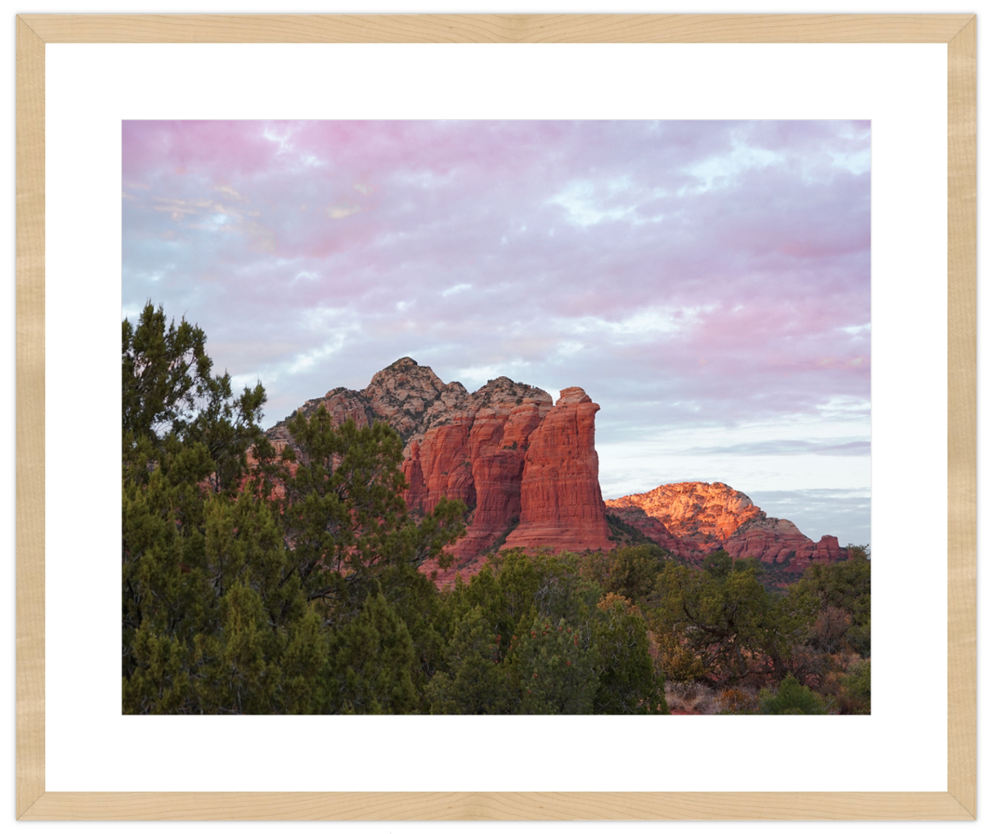 Framed photograph of a desert landscape with red rock formations and trees.