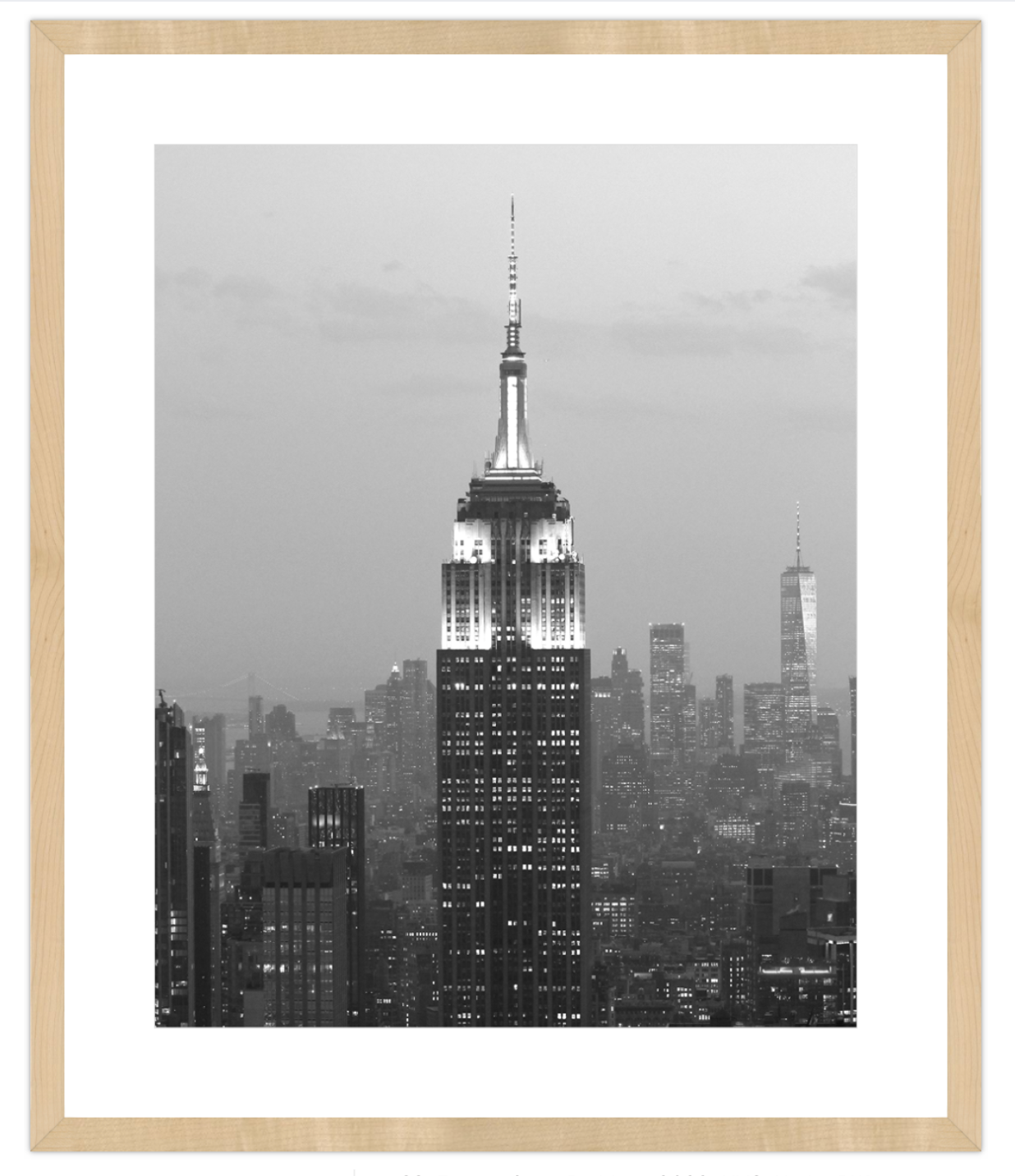 Framed black and white cityscape print with a prominent skyscraper.