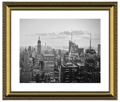 Framed black and white cityscape print with gold frame