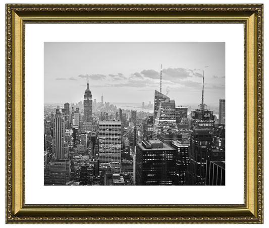 Framed black and white cityscape print with gold frame