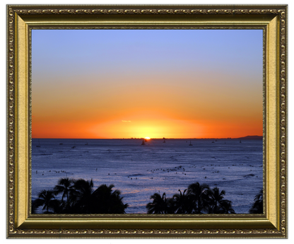 Sunset over the ocean with palm trees and a decorative gold frame.