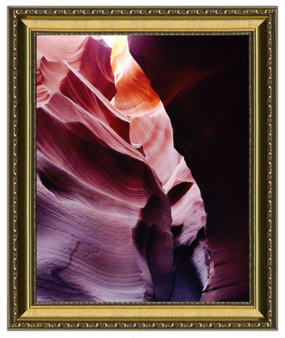 Framed photograph of a rock formation with a gold frame