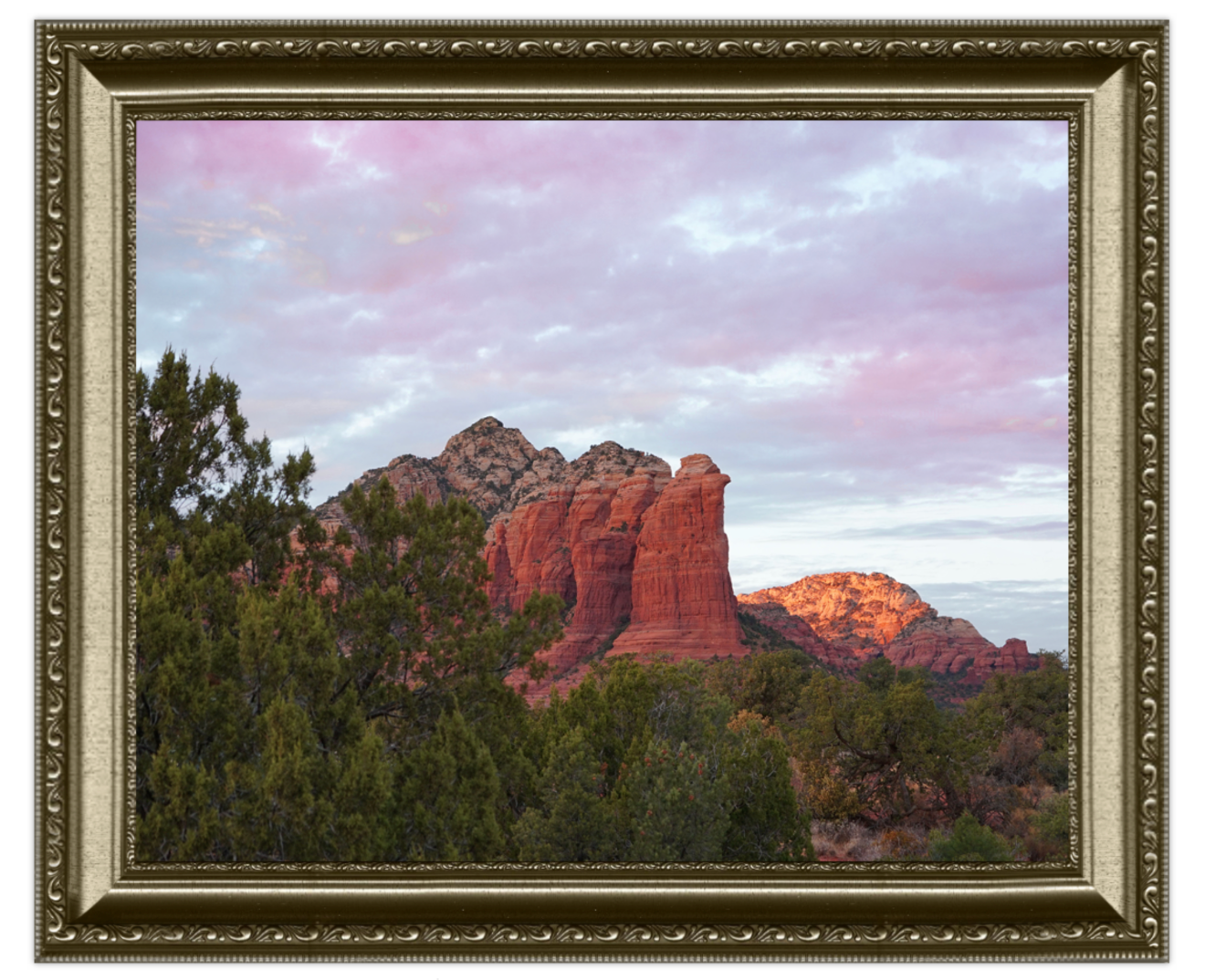 Framed photograph of a desert landscape with rock formations and trees.
