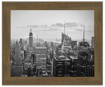 Framed black and white cityscape of a large metropolitan area with tall buildings.