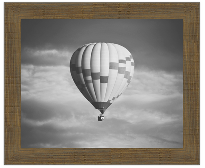 Hot air balloon in a cloudy sky with a wooden frame