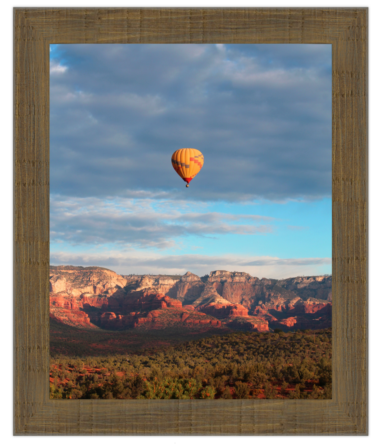 Hot air balloon over a desert landscape with a wooden frame