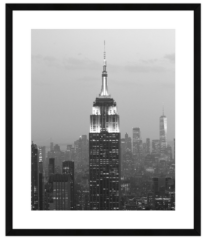 Framed black and white photo of a cityscape with a prominent skyscraper.