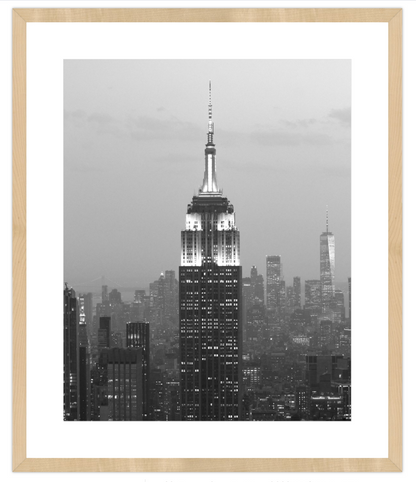 Framed black and white cityscape print with a prominent skyscraper.