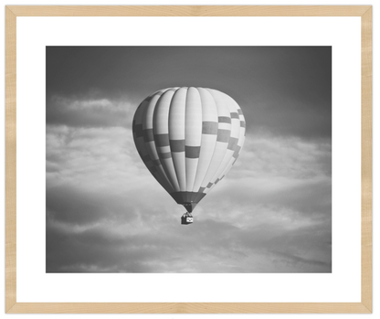 Hot air balloon in a cloudy sky with a wooden frame