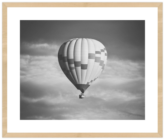 Hot air balloon in a cloudy sky with a wooden frame