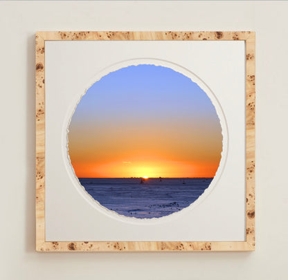 A collection of framed artwork prints with a deckled edge appearance, displayed in two museum style frames named Light Burlwood and Dark Burlwood. The frames are pictured in various sizes with a white mat and clear acrylic front.