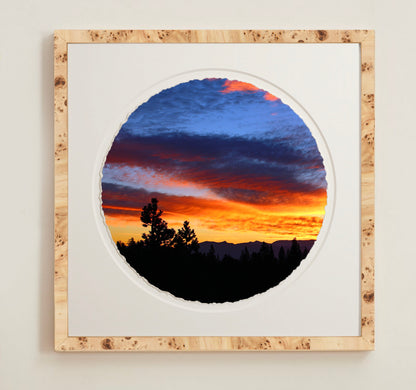 A collection of framed artwork prints with a deckled edge appearance, displayed in two museum style frames named Light Burlwood and Dark Burlwood. The frames are pictured in various sizes with a white mat and clear acrylic front.
