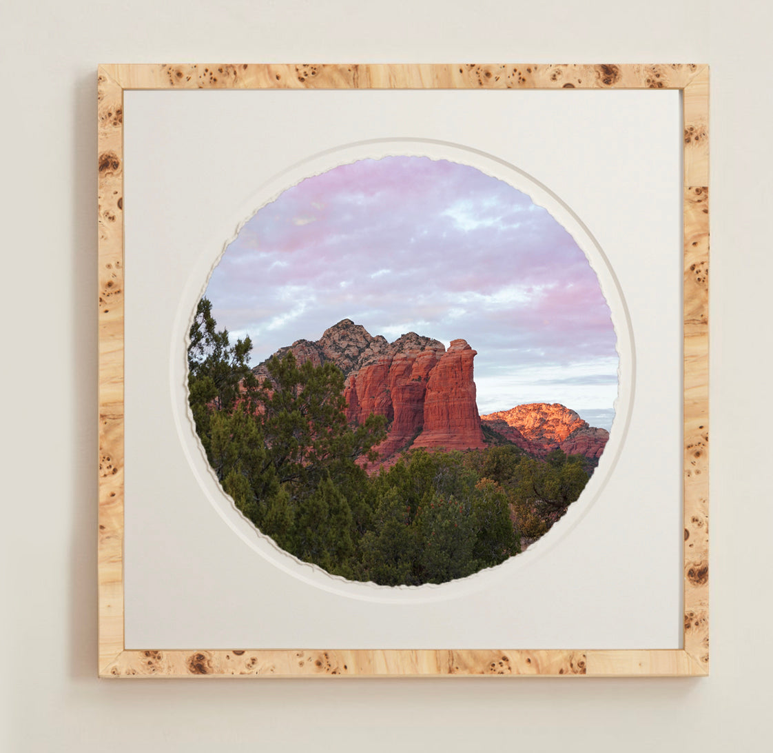 A collection of framed artwork prints with a deckled edge appearance, displayed in two museum style frames named Light Burlwood and Dark Burlwood. The frames are pictured in various sizes with a white mat and clear acrylic front.