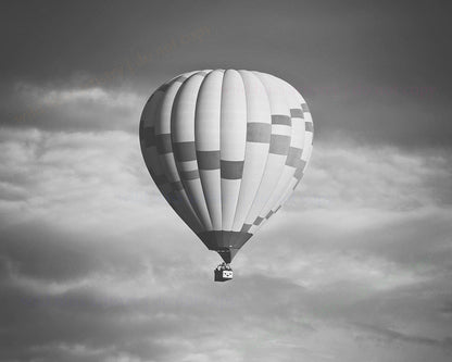 black and white image of large hot air balloon with clouds