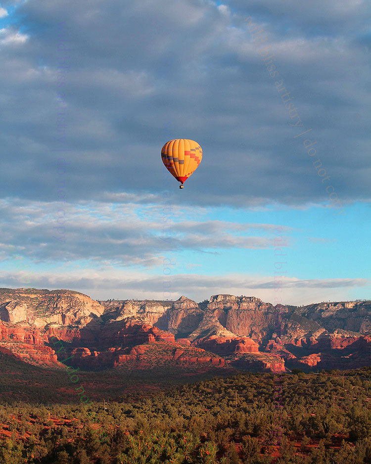 hot air balloon in the sky over sedona arizona's red rock landscape