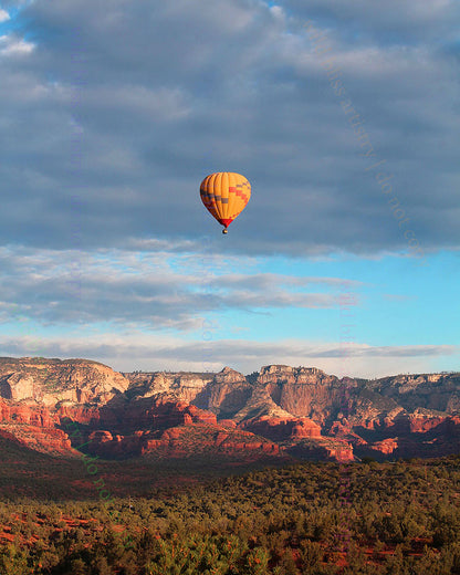 hot air balloon in the sky over sedona arizona's red rock landscape
